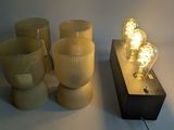 a light that is sitting on a table next to some cups