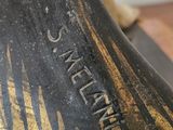 a statue of a bell that is on a wooden table