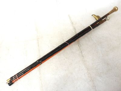 an image of a long wooden stick with a black handle on a white surface