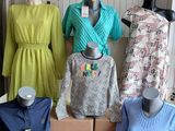 several mannequins and dresses are on display in a clothing store
