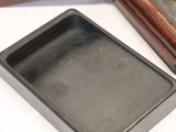 two small metal trays sitting on top of a table next to each other