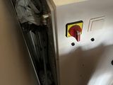 a white refrigerator with a red and yellow sticker on it