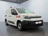 the white van is parked in a large room with a red and white stripe on the side of the van