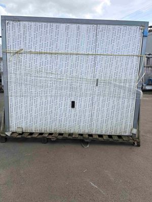 a large white box on a pallet in a parking lot