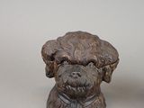 two figurines of dogs sitting next to each other