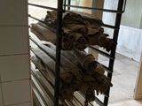 a rack with rolls of fabric on it in a room
