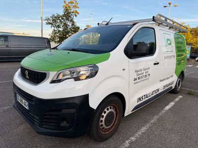 a green and white van that is parked in a parking lot