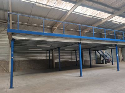 un entrepôt vide avec un toit en tôle et un escalier en métal