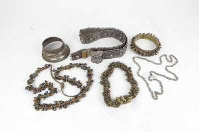 several pieces of jewelry are laying out on a white surface