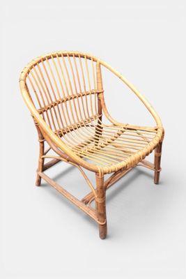 an image of a rattan chair with a wooden frame on a white background