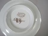 a white plate with a brown writing on it