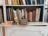 a cabinet with books on top of it in a room
