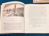 an open book with a picture of a man and a woman on a boat