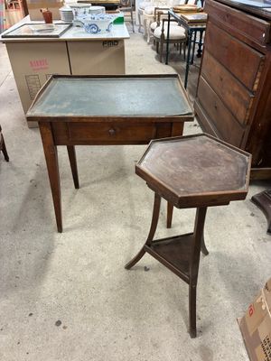 a small table with a glass top and a small table with a drawer underneath it