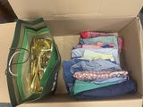 a box full of clothes and a bag with a gold spoon in it