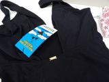 a book on a bed next to a black bra top