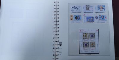 an open book with stamps on it sitting on a table