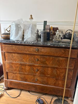 une commode avec un plateau en marbre dans une pièce