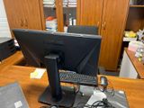 a desk with a monitor, keyboard, mouse and a laptop on it