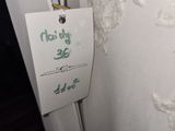 a label on the back of a white dress with lace on it