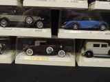 a lot of different model cars on display in a case