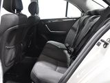 the back seats of a car with the door open in a car showroom