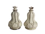 pair of white ceramic salt and pepper shakers on a white background