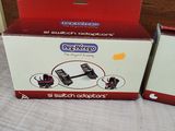 packaging of a red and white microwave sitting on top of a bed