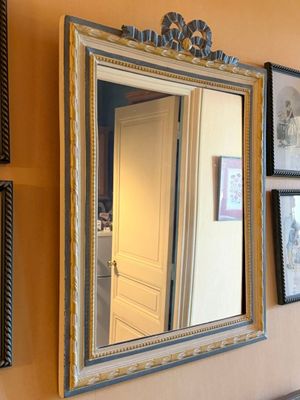 a mirror hanging on the wall next to a sink