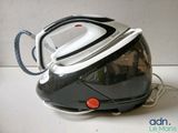 a black and white steam iron sitting on a counter