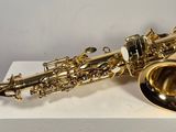 a close up of a saxophone sitting on a white box