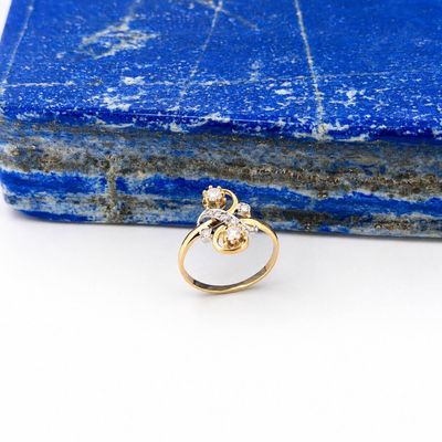 a close up of a gold ring on top of a blue stone