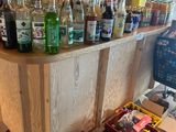 many bottles of alcohol sitting on the counter in the store