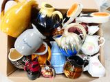 a cardboard box filled with many different types of vases
