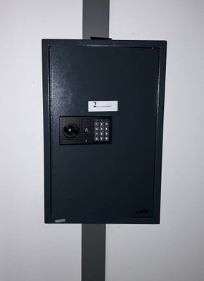 a black safe box with a key on it