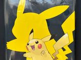 a close up of a pokemon pikachu sticker on a black surface