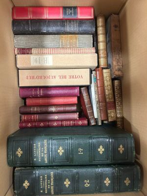 a box full of books that are stacked on top of each other