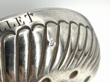 a close up of a silver spoon with a name on it