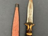 two knives are sitting next to each other on a table