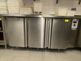 a stainless steel kitchen with a lot of dishes on the counter