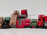 many toy trains that are lined up together on the table