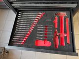 a lot of tools in a tool box on the floor