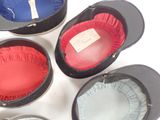 several hats are lined up in a circle on a white surface