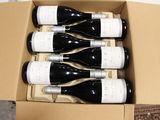 six bottles of wine in a cardboard box on the floor