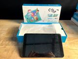 a tablet that is sitting on a table in front of a box