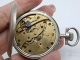 a close up of a pocket watch in someone ' s hand