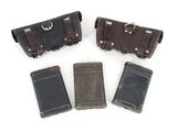four old suitcases are lined up in a row on a white surface
