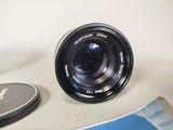 a camera lens sitting on top of a table next to a cell phone