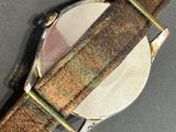 an image of a close up of a watch on a table
