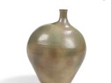 a brown vase that is sitting on a white surface
